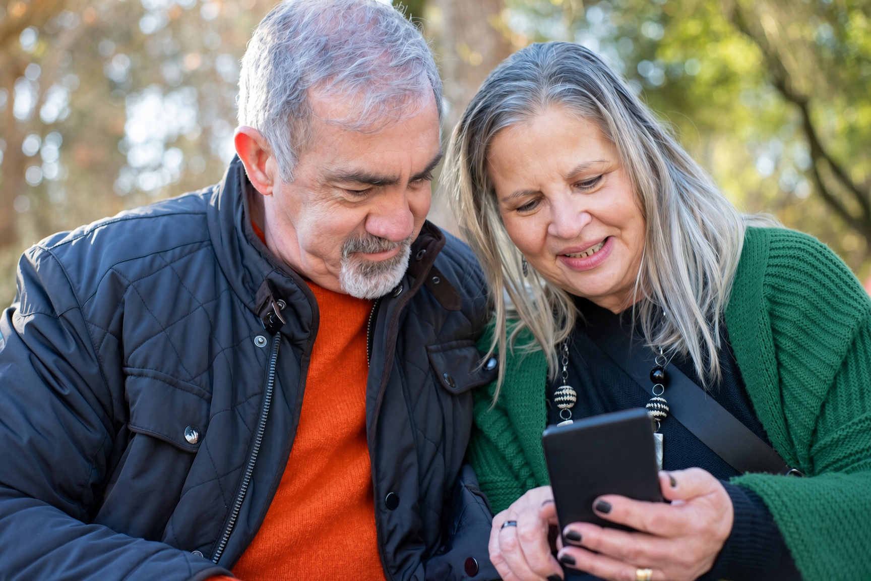 Happy couple reviewing Medicare options with an agent
